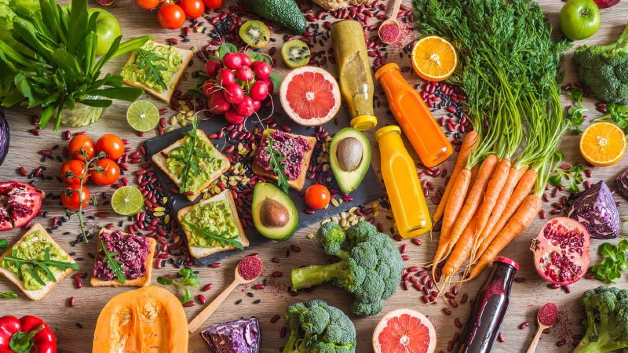 Healthy vegan food. Sandwiches and fresh vegetables on wooden background. Detox diet. Different colorful fresh juices. top view